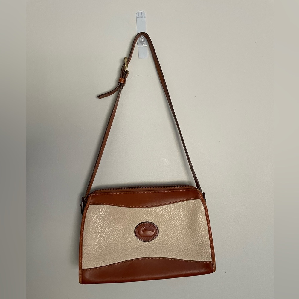 Off white and cognac vintage Dooney and Bourke leather shoulder bag.